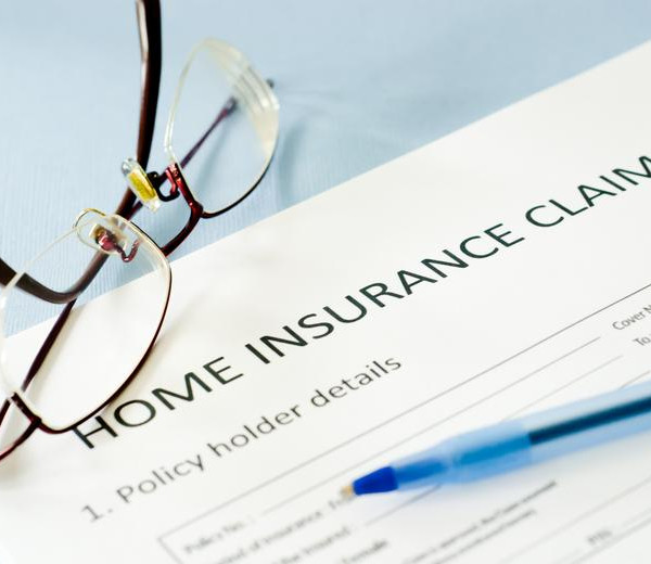 spectacles a pen kept on a paper written home insurance claim