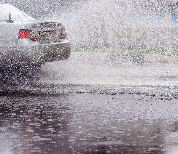 car is passing by in the rainy roads